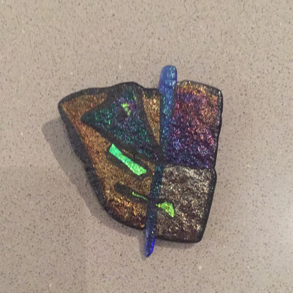 Ceramic brooch with iridescent glazes.